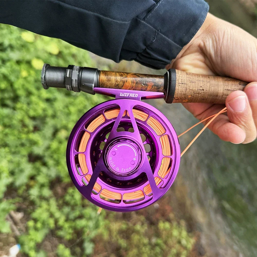 Side view of the purple Wifreo Alpha fly reel mounted on a fly rod outdoors