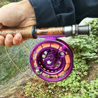 Purple enclosed fly reel shown in a river fishing scene